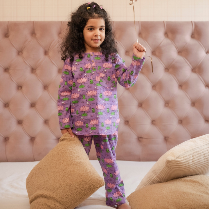 Lotus Print PJ set Loungewear A child holding a balloon, wearing a pink and purple lotus print pajama set with pockets.
