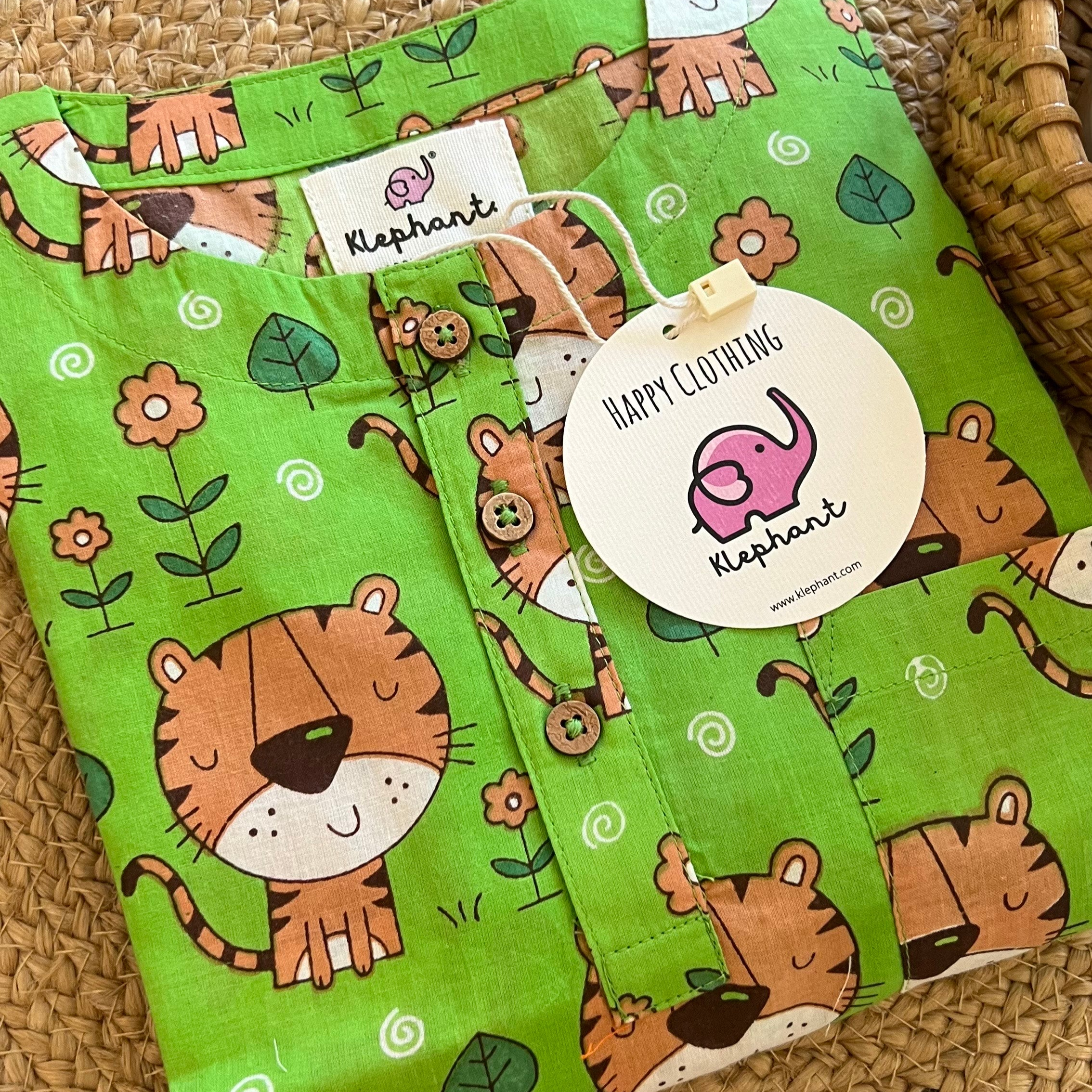 Green Tiger Night Suit Set Loungewear A Green Tiger Kurta Set with a pattern of tigers and leaves displayed on a wicker table.