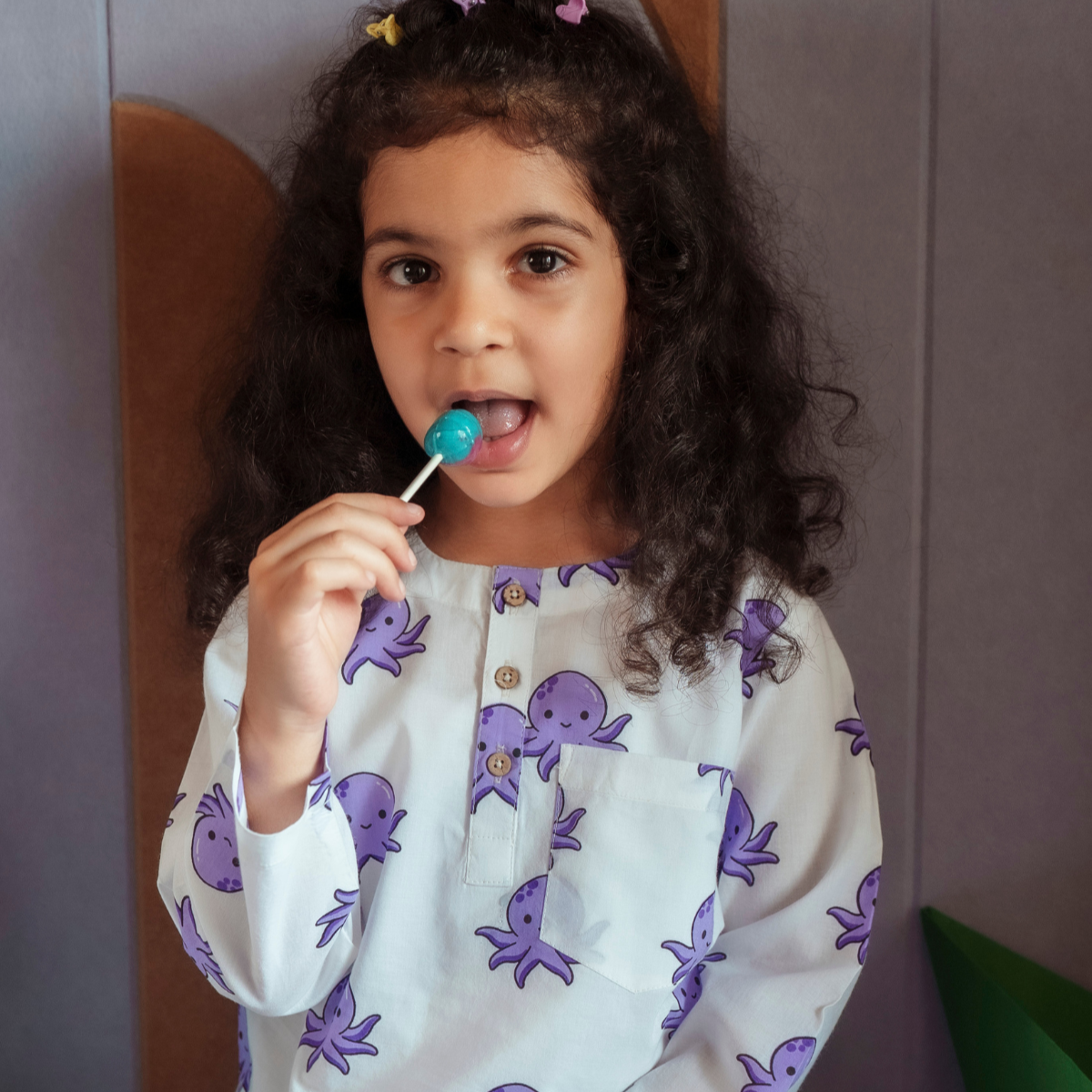 Octopus Print PJ set Sleepwear A child sitting and smiling while wearing a white and purple octopus print pajama set